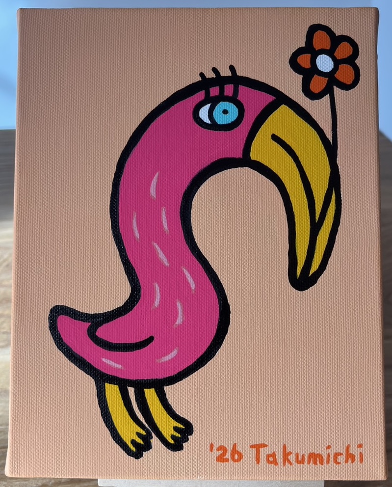 花をくわえるフラミンゴ